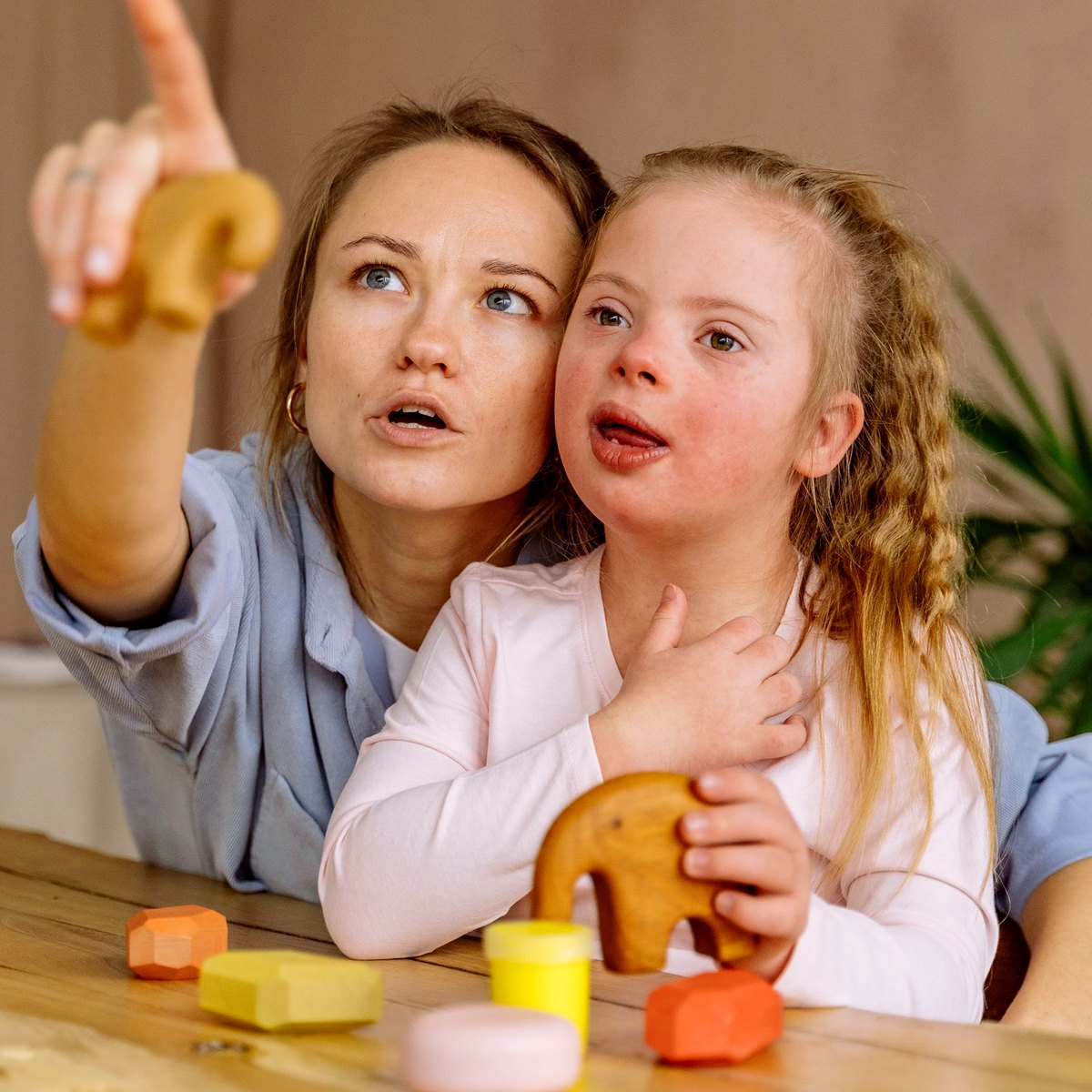 Support worker sitting with a child during a home activity